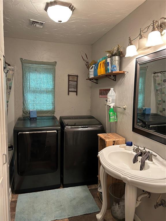 bathroom featuring washer and dryer