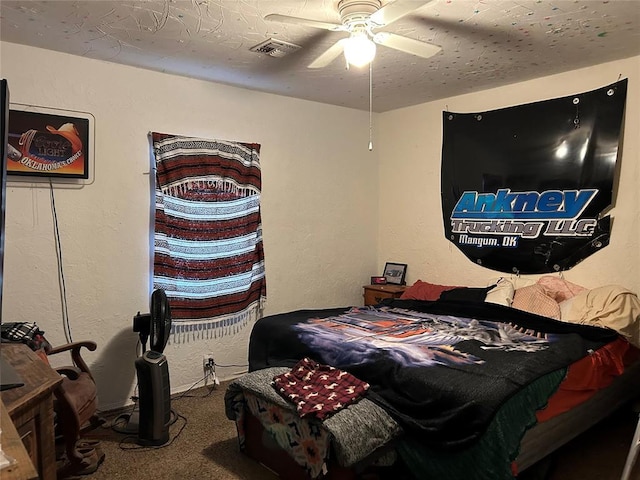 carpeted bedroom with a textured ceiling and ceiling fan