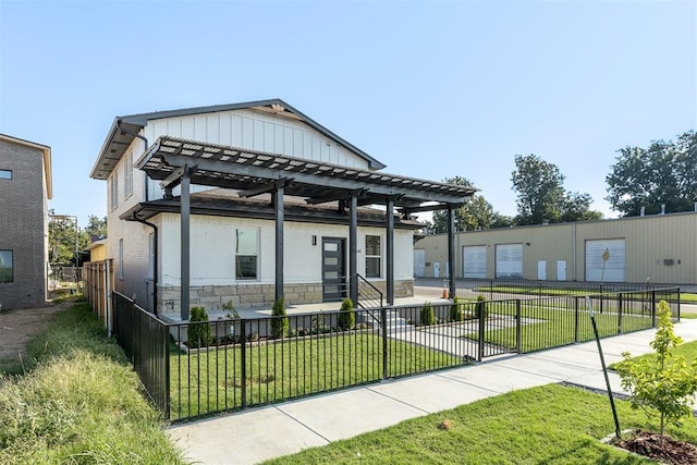 view of front facade with a pergola and a front lawn