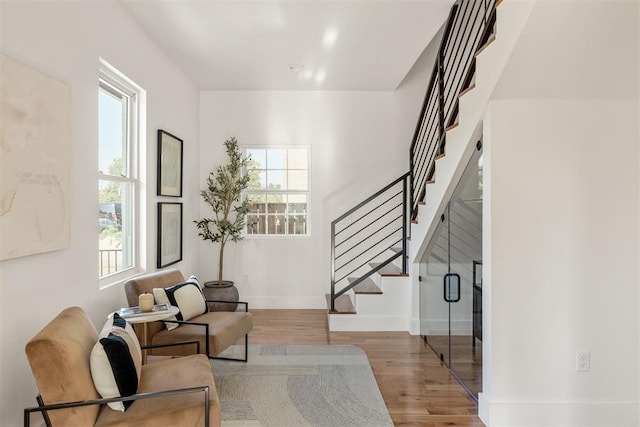 living room featuring a healthy amount of sunlight and light hardwood / wood-style flooring