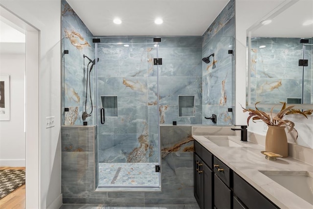 bathroom with vanity, wood-type flooring, and a shower with door