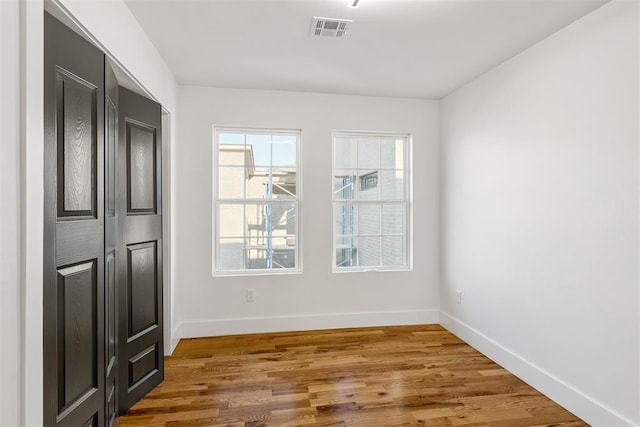 unfurnished room featuring hardwood / wood-style flooring