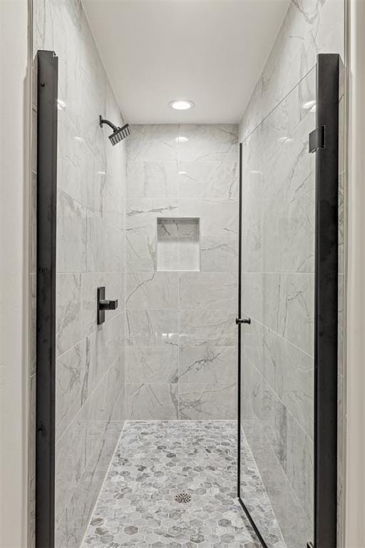 bathroom with a tile shower