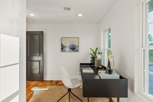 home office with wood-type flooring