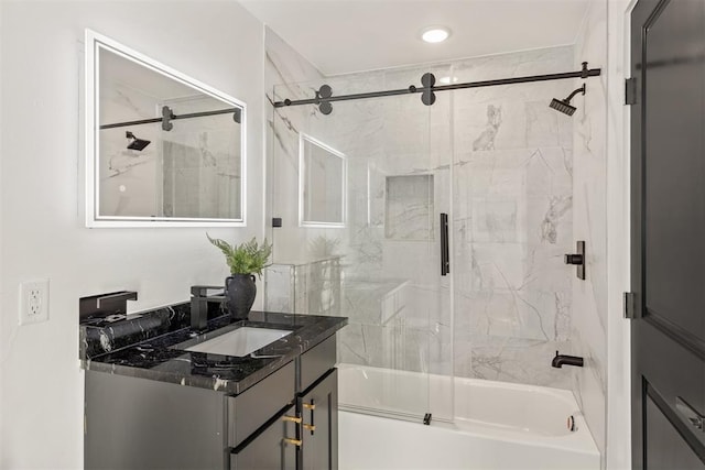 bathroom with vanity and combined bath / shower with glass door