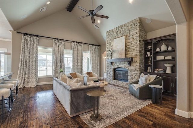 living room with a stone fireplace, vaulted ceiling with beams, dark hardwood / wood-style floors, built in features, and ceiling fan