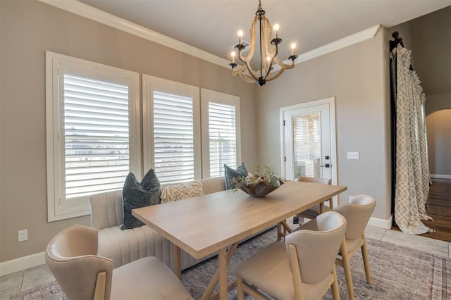 tiled dining room featuring ornamental molding, a healthy amount of sunlight, and a notable chandelier