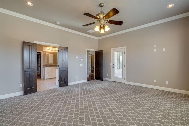 unfurnished bedroom with ceiling fan, ornamental molding, light carpet, and ensuite bath