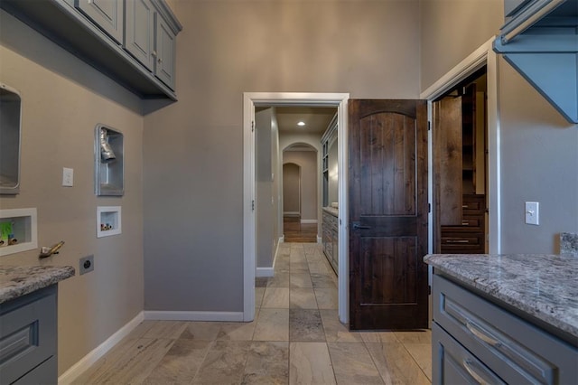 interior space featuring cabinets, hookup for an electric dryer, and hookup for a washing machine