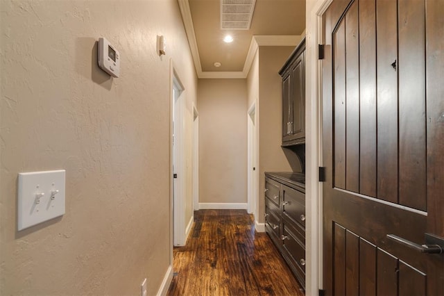 hallway with crown molding and dark hardwood / wood-style flooring