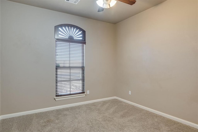 carpeted empty room featuring ceiling fan