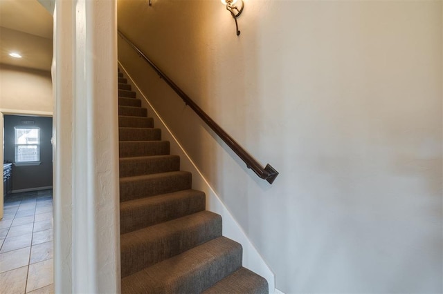 stairway with tile patterned flooring