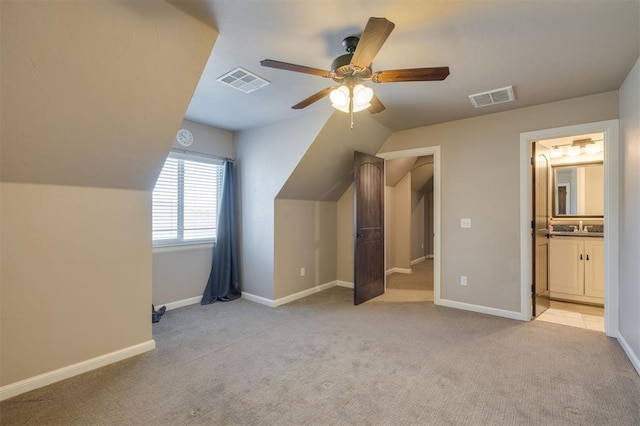 additional living space featuring light carpet, sink, lofted ceiling, and ceiling fan