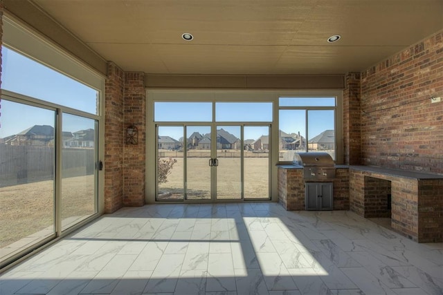 unfurnished sunroom with plenty of natural light