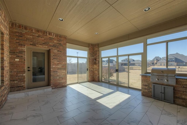 unfurnished sunroom featuring wood ceiling