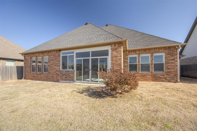 rear view of property with a yard