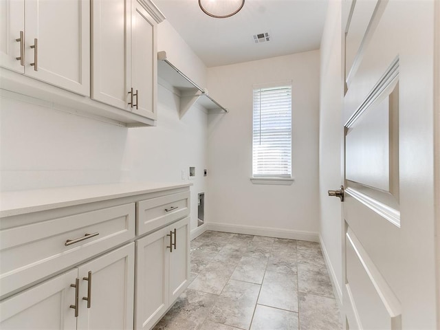 laundry room featuring cabinets and electric dryer hookup