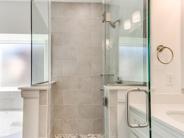 bathroom with vanity and a shower with shower door