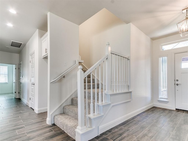 entryway featuring an inviting chandelier and a healthy amount of sunlight