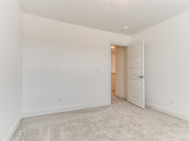 unfurnished room with light colored carpet