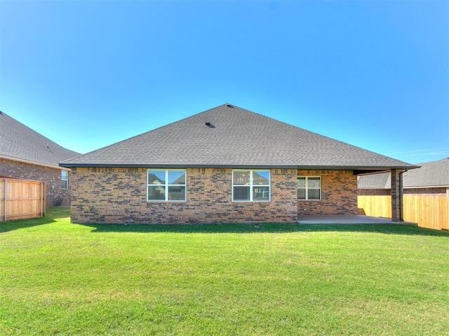 back of house with a yard and a patio area