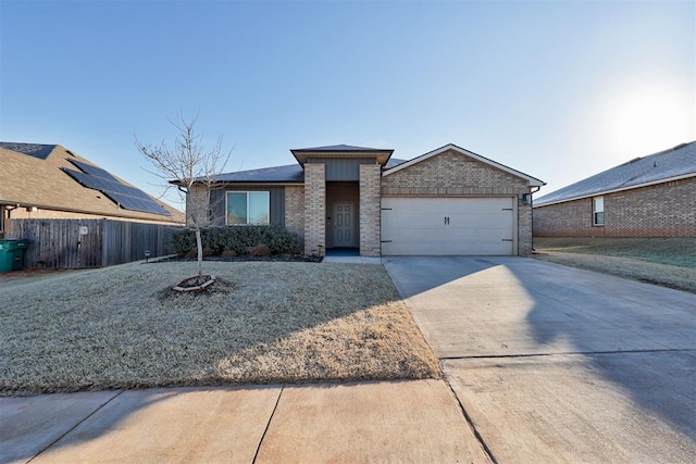 view of front of home with a garage and a front lawn