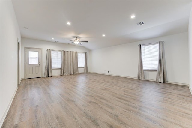 spare room featuring ceiling fan, lofted ceiling, and light hardwood / wood-style flooring