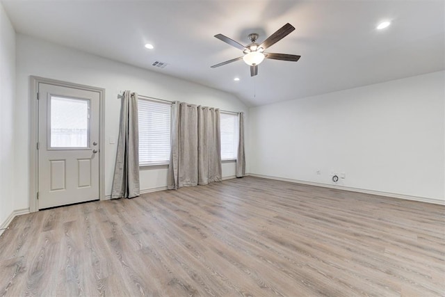 interior space with light hardwood / wood-style flooring, plenty of natural light, ceiling fan, and vaulted ceiling