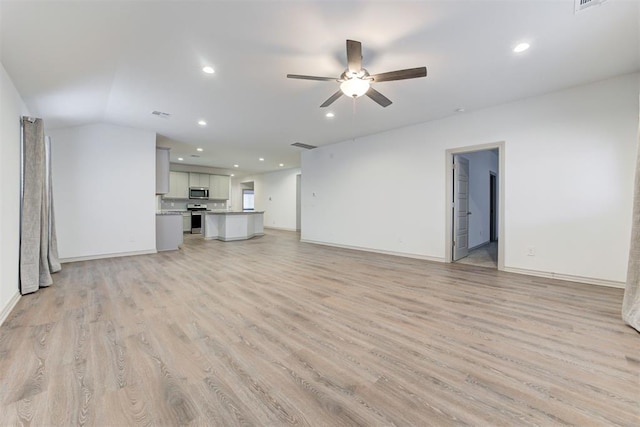 unfurnished living room featuring ceiling fan and light hardwood / wood-style flooring