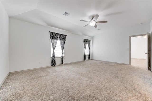 empty room with lofted ceiling, carpet floors, and ceiling fan