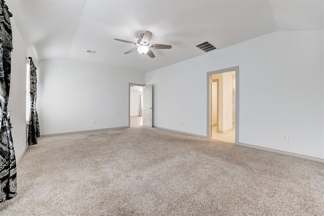 carpeted spare room with ceiling fan and lofted ceiling