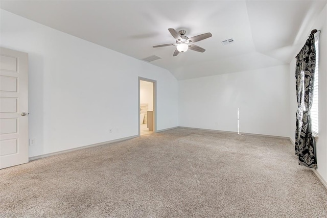 carpeted spare room featuring lofted ceiling and ceiling fan