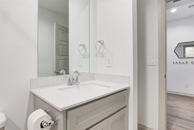 bathroom featuring vanity and toilet