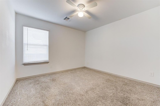 spare room featuring carpet floors and ceiling fan