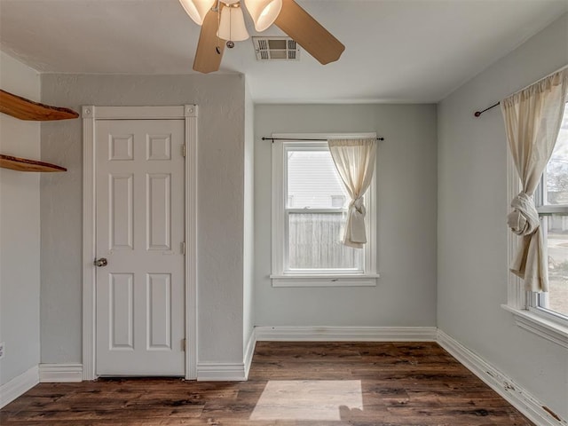 interior space featuring wood finished floors, visible vents, and baseboards