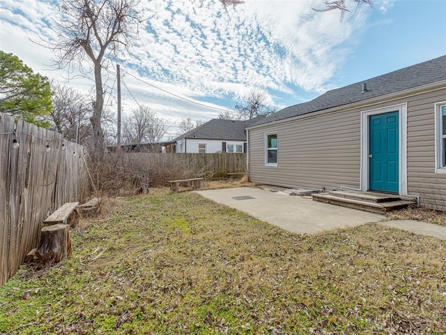 view of yard with a patio area and a fenced backyard