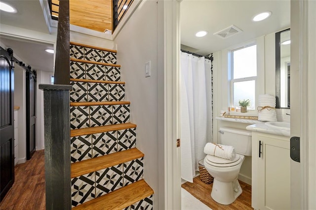 bathroom featuring vanity, hardwood / wood-style floors, toilet, and a shower with shower curtain