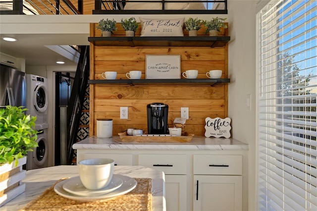 interior space with stacked washer and clothes dryer