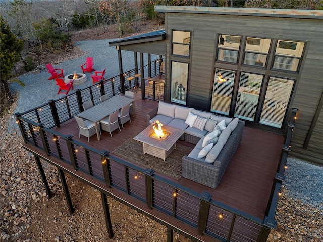 deck featuring an outdoor living space with a fire pit