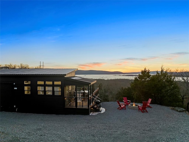 exterior space with a mountain view, a patio area, and an outdoor fire pit