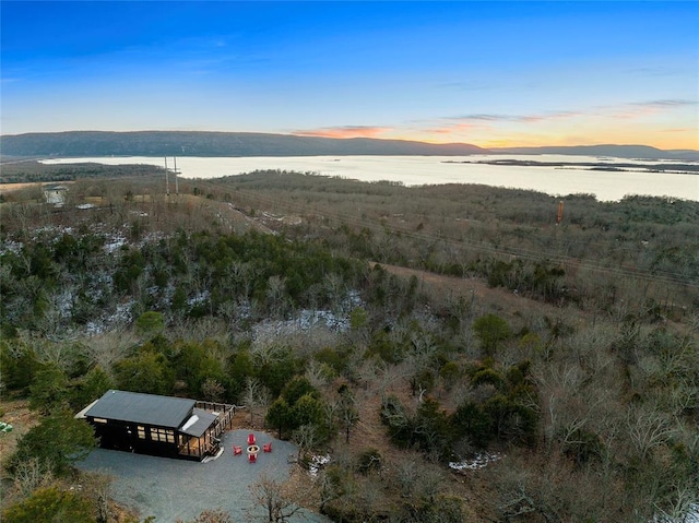 aerial view at dusk with a water and mountain view