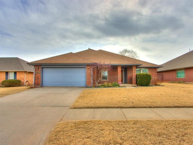 ranch-style house with a garage and a front lawn