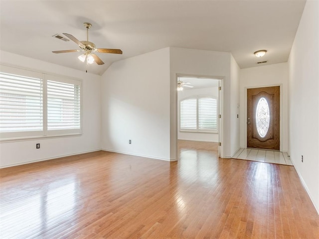 entryway featuring ceiling fan, lofted ceiling, and light hardwood / wood-style flooring