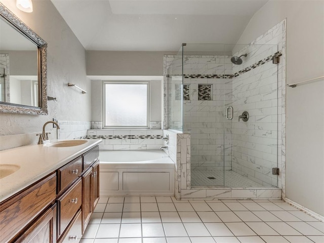 bathroom featuring tile patterned flooring, shower with separate bathtub, lofted ceiling, and vanity