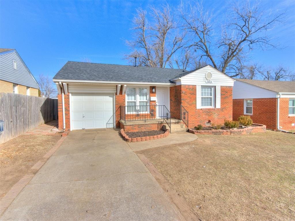 ranch-style house with a garage and a front lawn