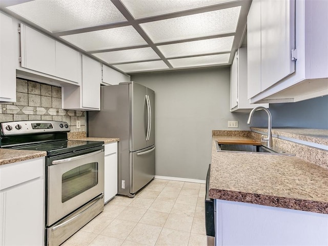 kitchen featuring tasteful backsplash, white cabinetry, appliances with stainless steel finishes, and sink