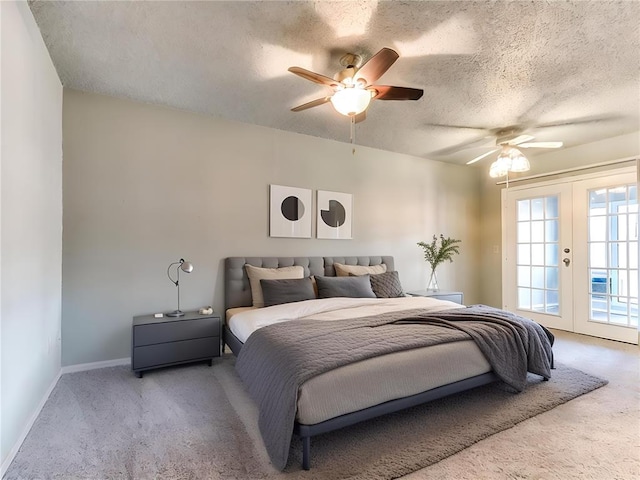 carpeted bedroom with french doors, ceiling fan, access to exterior, and a textured ceiling