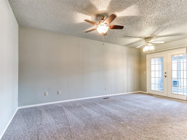 empty room with carpet flooring, a textured ceiling, ceiling fan, and french doors