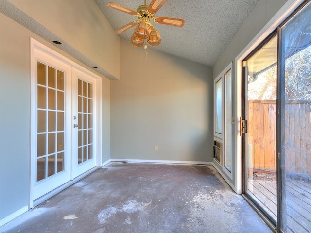 unfurnished sunroom featuring french doors, ceiling fan, and lofted ceiling