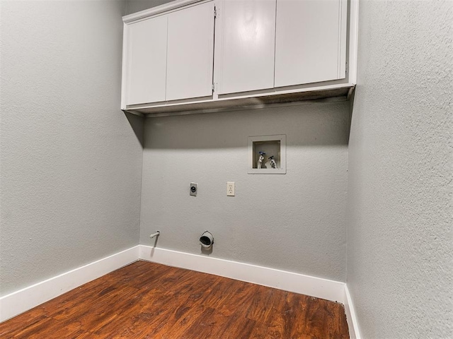 clothes washing area featuring gas dryer hookup, hardwood / wood-style floors, cabinets, washer hookup, and hookup for an electric dryer